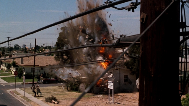 Wide shot frame from Lethal Weapon — walking, street, fire