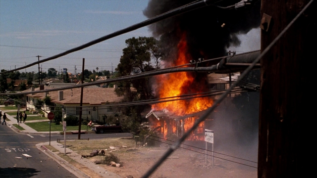 Wide shot frame from Lethal Weapon — walking, street, fire