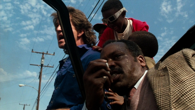 Medium shot frame from Lethal Weapon — standing, dialogue, street