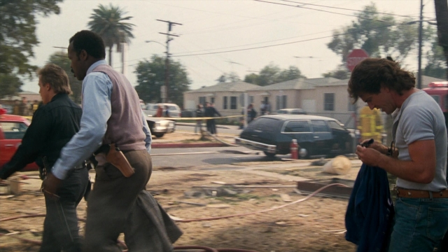 Wide shot frame from Lethal Weapon — walking, street, fire