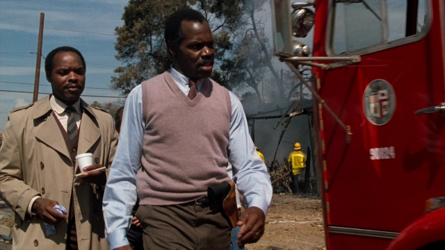Wide shot frame from Lethal Weapon — walking, street, fire