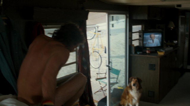 Frame from Lethal Weapon — sitting, dog, suit