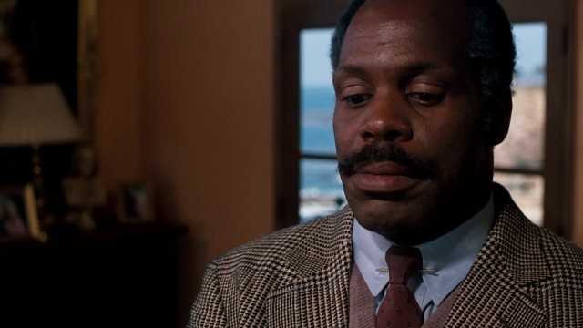 Close-up frame from Lethal Weapon — room, suit, tie