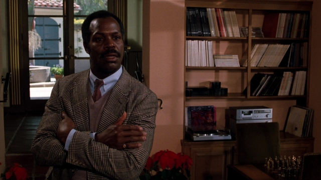 Medium shot frame from Lethal Weapon — book, standing, room