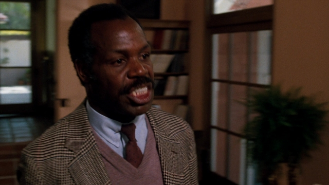Medium shot frame from Lethal Weapon — standing, room, suit