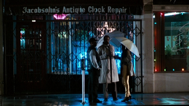 Wide shot frame from Lethal Weapon — standing, street, hat