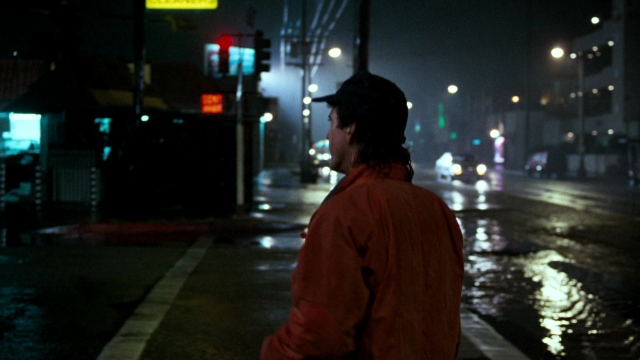 Medium shot frame from Lethal Weapon — standing, street, hat