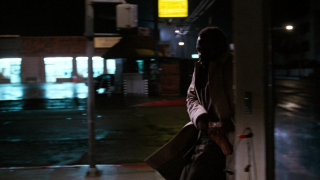 Wide shot frame from Lethal Weapon — standing, door, street