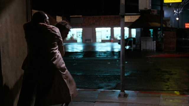Wide shot frame from Lethal Weapon — standing, street, coat