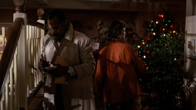 Wide shot frame from Lethal Weapon — standing, coat, hand