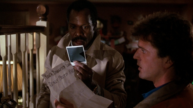 Medium shot frame from Lethal Weapon — standing, room, dialogue