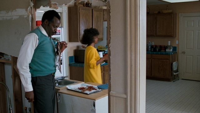 Wide shot frame from Lethal Weapon — standing, plate, room