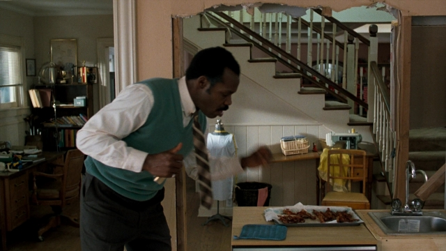 Frame from Lethal Weapon — standing, table, house