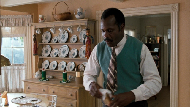 Wide shot frame from Lethal Weapon — standing, table, dialogue