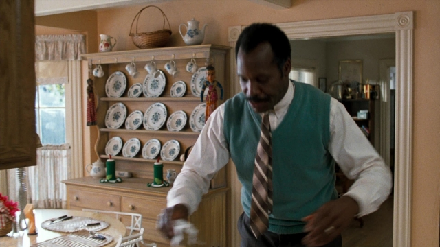 Wide shot frame from Lethal Weapon — table, dialogue, kitchen