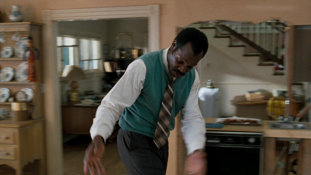 Wide shot frame from Lethal Weapon — standing, room, kitchen