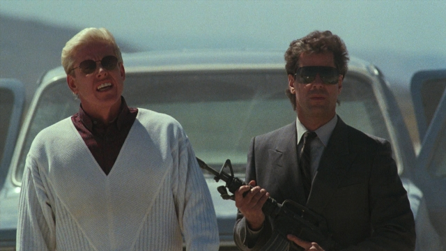 Wide shot frame from Lethal Weapon — standing, hand, suit