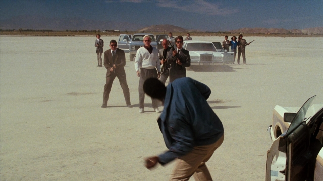 Wide shot frame from Lethal Weapon — standing, car, person