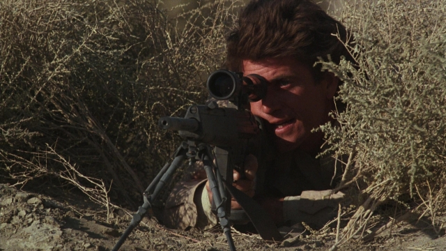 Wide shot frame from Lethal Weapon — uniform, gun, face
