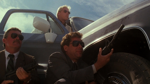 Frame from Lethal Weapon — sitting, car, suit
