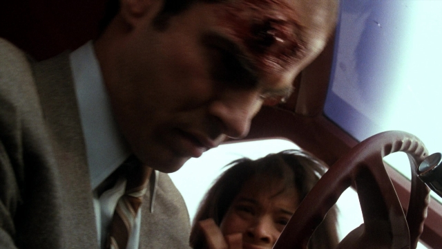Wide shot frame from Lethal Weapon — sitting, street, car