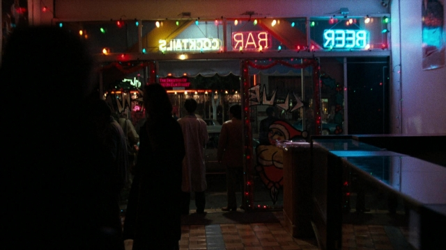 Wide shot frame from Lethal Weapon — standing, night, restaurant