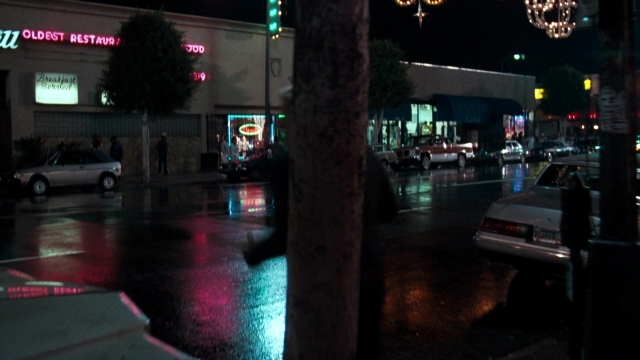 Wide shot frame from Lethal Weapon — street, car, night