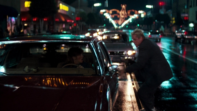 Wide shot frame from Lethal Weapon — standing, door, street
