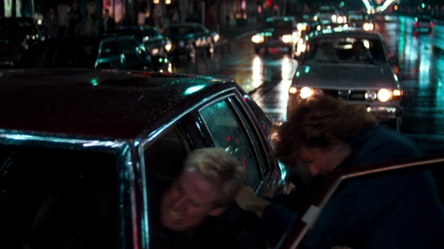 Wide shot frame from Lethal Weapon — sitting, walking, street