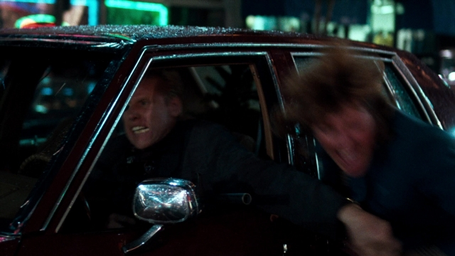 Wide shot frame from Lethal Weapon — sitting, street, car