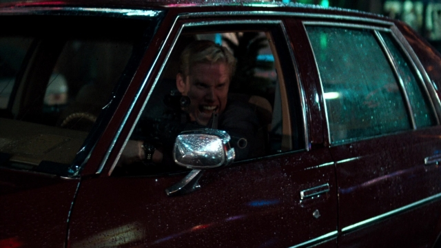 Wide shot frame from Lethal Weapon — sitting, street, mirror