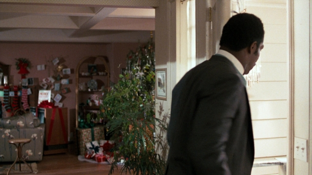 Wide shot frame from Lethal Weapon — standing, room, table