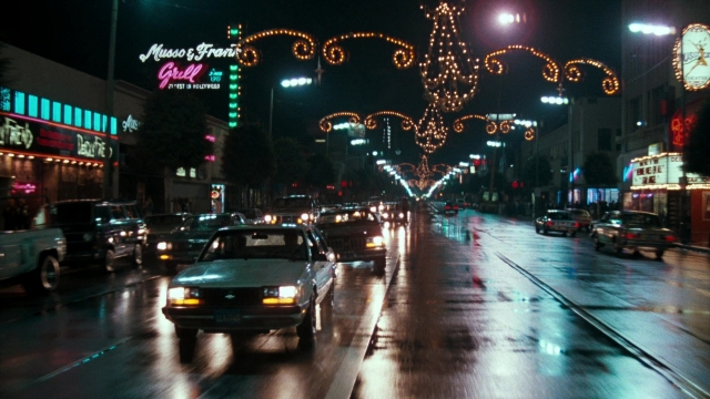 Wide shot frame from Lethal Weapon — street, car, night