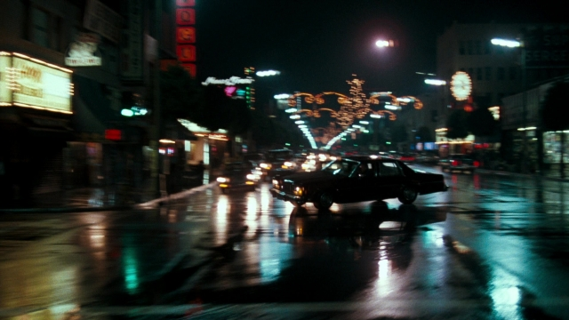 Wide shot frame from Lethal Weapon — street, car, night