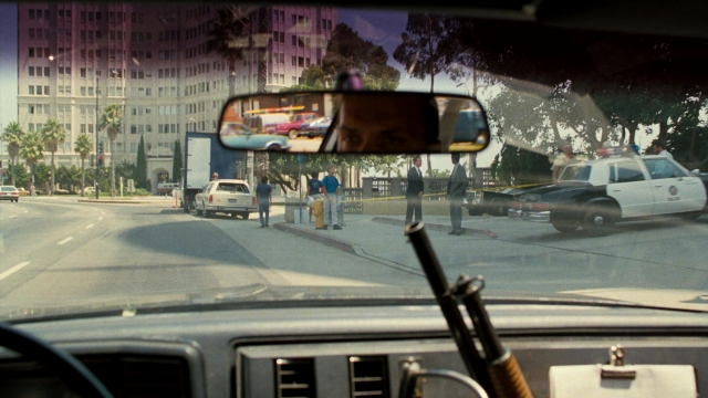 Wide shot frame from Lethal Weapon — standing, street, car
