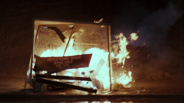 Wide shot frame from Lethal Weapon — fire, furniture, smoke