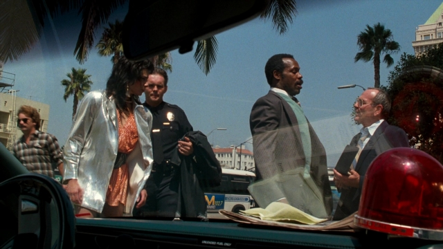 Wide shot frame from Lethal Weapon — standing, street, car