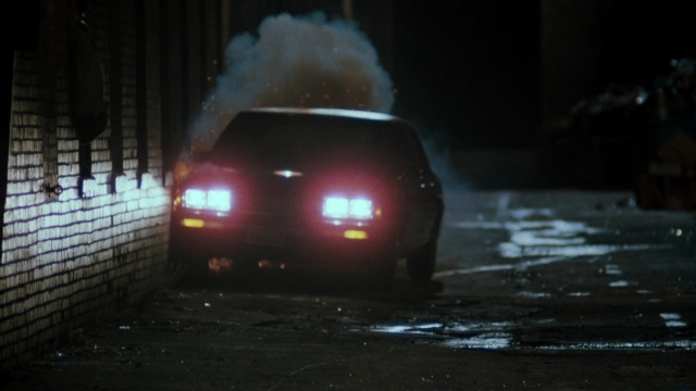 Wide shot frame from Lethal Weapon — street, fire, car