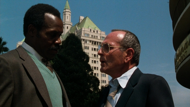 Frame from Lethal Weapon — standing, dialogue, suit