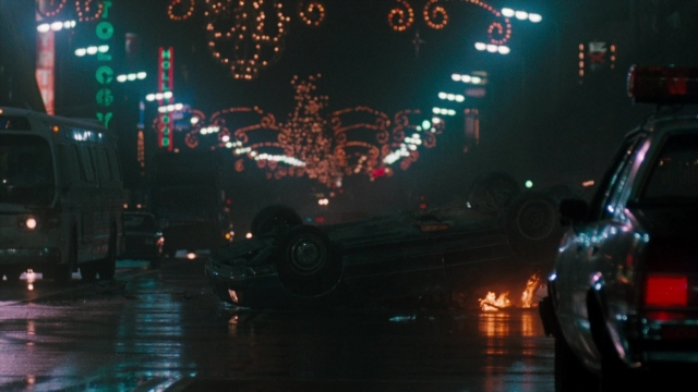 Wide shot frame from Lethal Weapon — street, car, night