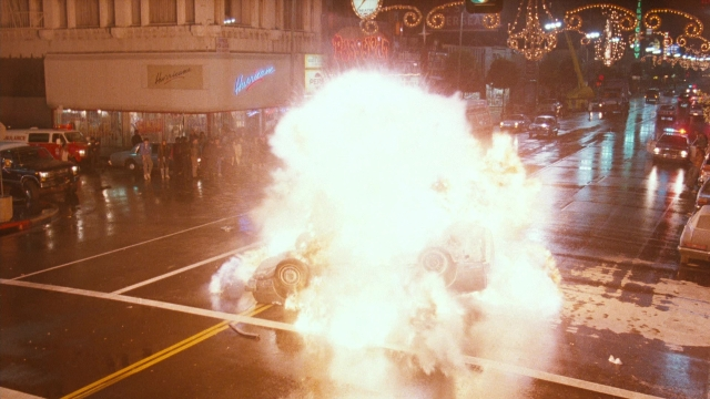 Wide shot frame from Lethal Weapon — street, fire, car