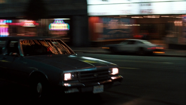 Wide shot frame from Lethal Weapon — street, car, night