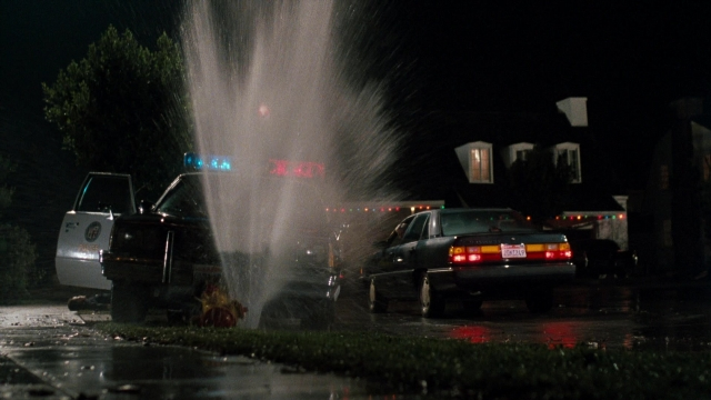 Wide shot frame from Lethal Weapon — street, car, night
