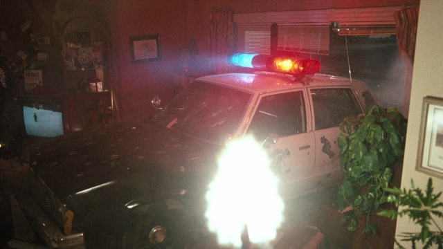 Wide shot frame from Lethal Weapon — room, car, houseplant