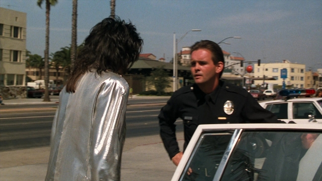 Wide shot frame from Lethal Weapon — standing, street, uniform