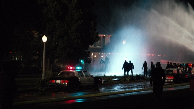 Wide shot frame from Lethal Weapon — standing, street, fire