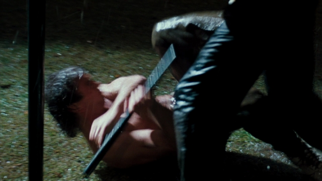 Wide shot frame from Lethal Weapon — hand, knife, person