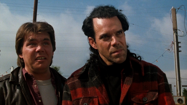 Medium shot frame from Lethal Weapon — standing, street, jacket