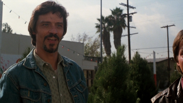 Medium shot frame from Lethal Weapon — standing, street, jacket