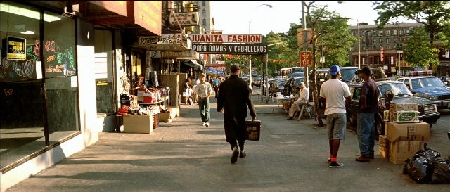 Wide shot frame from Léon — walking, street, person